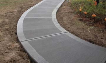 stamped concrete path that is around the edge of a residential property