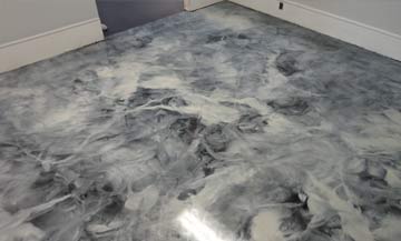 White, gray and black marble epoxy floor installed in a beauty salon store room