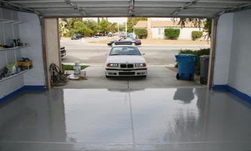 gray epoxy flooring in a two car garage with BMW in the driveway