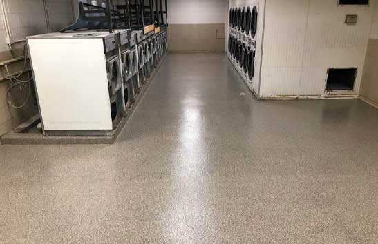 brown flake epoxy flooring installed in a Laundromat
