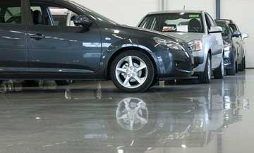 epoxy flooring over bare concrete in a showroom for a car dealership