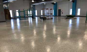 entire view of high school orchestra space that has been done with tan epoxy flooring