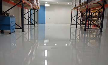 white full gloss epoxy flooring in a commercial waste facility